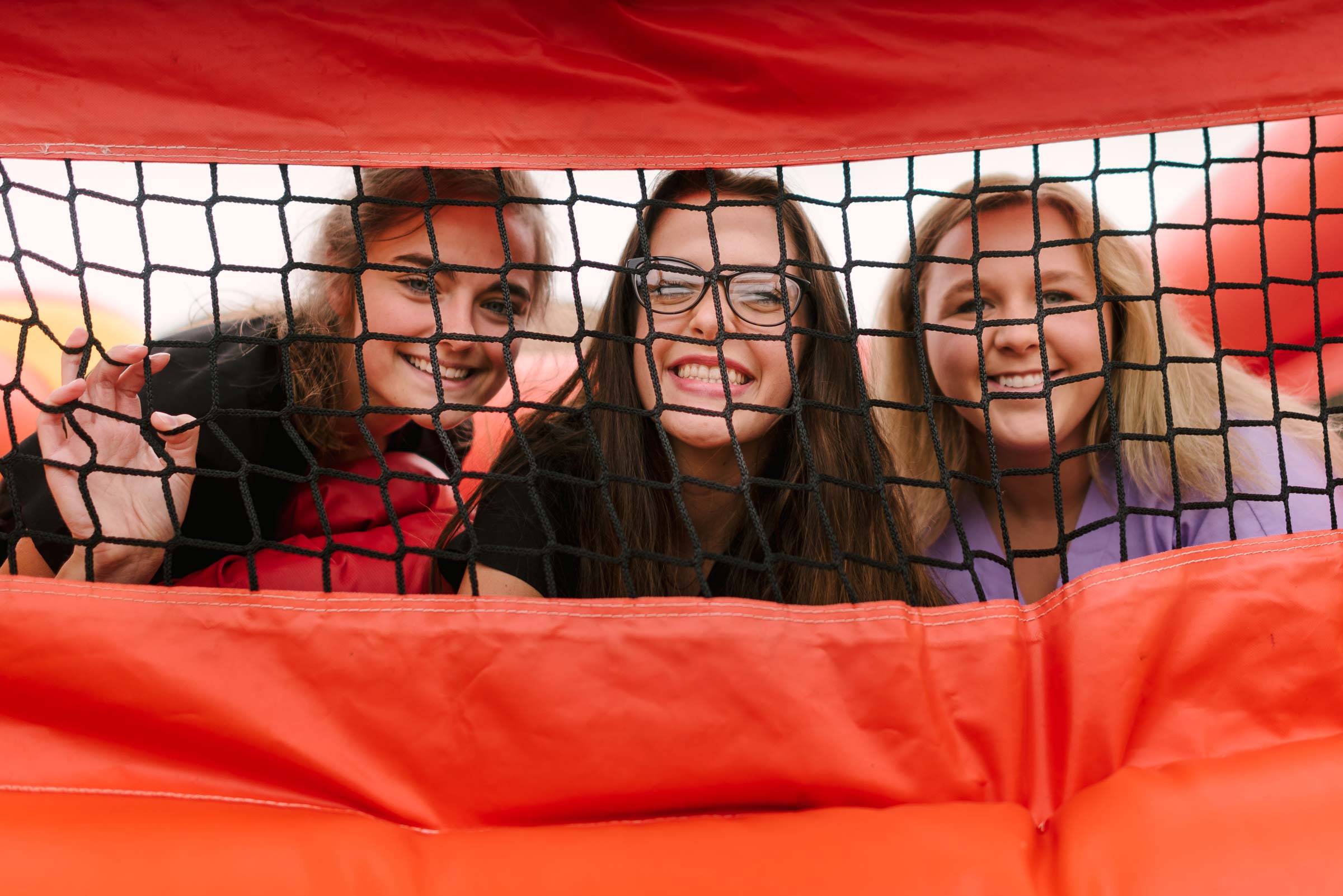 Students smiling in a bounce house