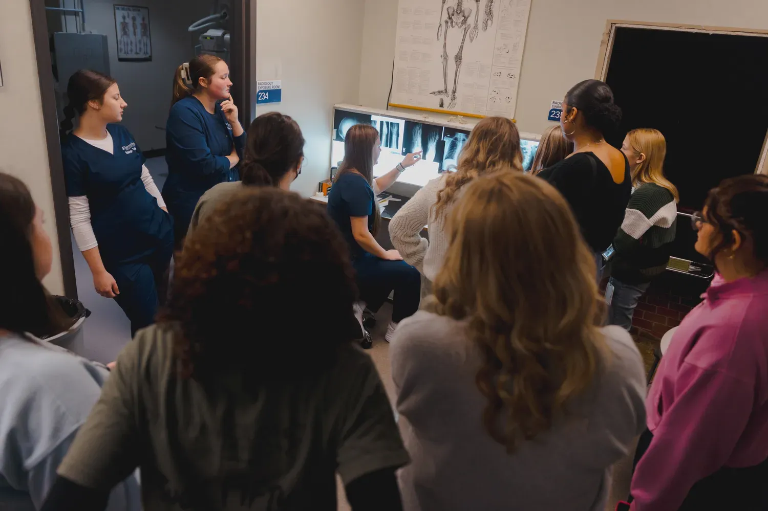 students looking at X ray image with professor