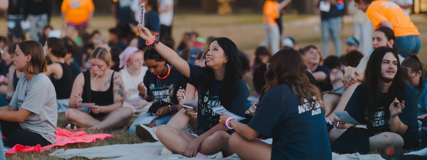 Group of students sitting on the grass at WOW