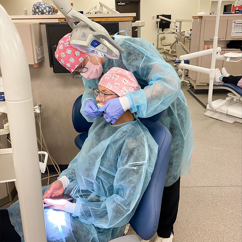 Student getting impressions taken in dental lab