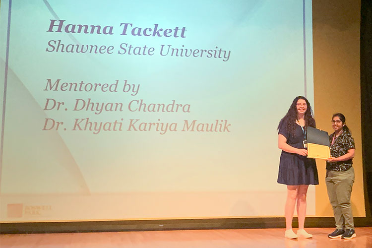 Hannah Tackett receiving an award on stage
