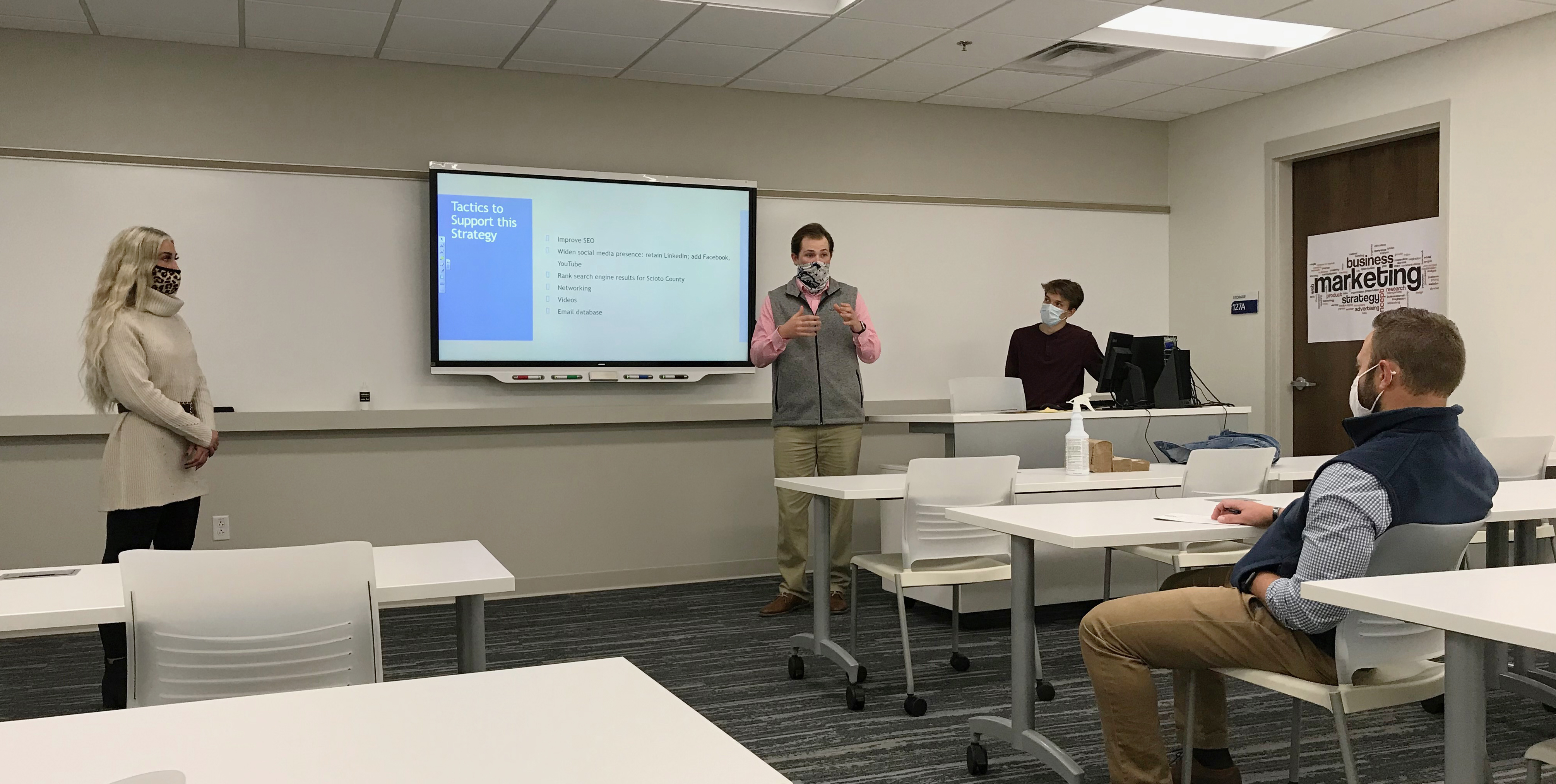 Marketing majors Madison Campbell, Drew Lowe and Owen Reeher present a proposal to local client Matt Setters, CEO of Setters CPA & Co.