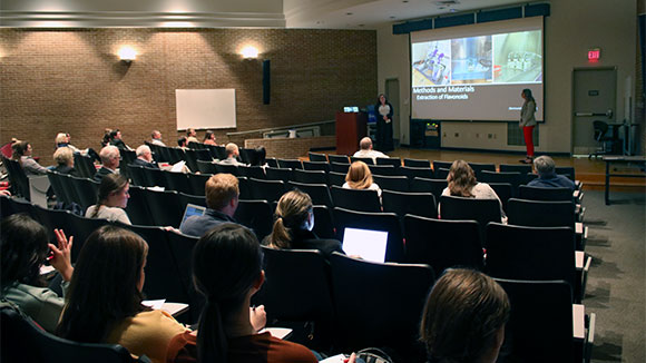 picture of students giving presentation in lecture hall