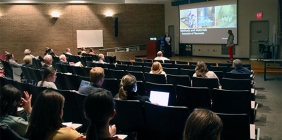 picture of students giving presentation in lecture hall