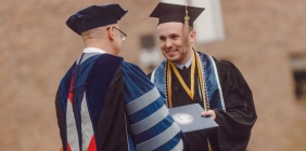 photo of student receiving diploma at graduation