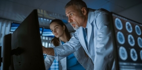 technicians looking at medical information on a computer screen