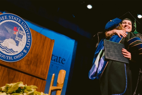 Student on Stage with Diploma