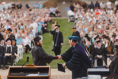 SSU graduate receiving diploma at commencement ceremony